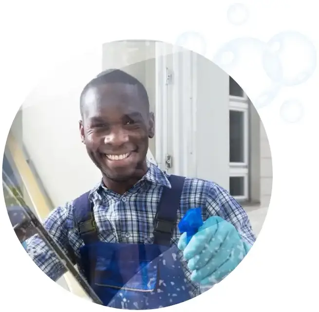 A man holding a spray bottle and smiling.