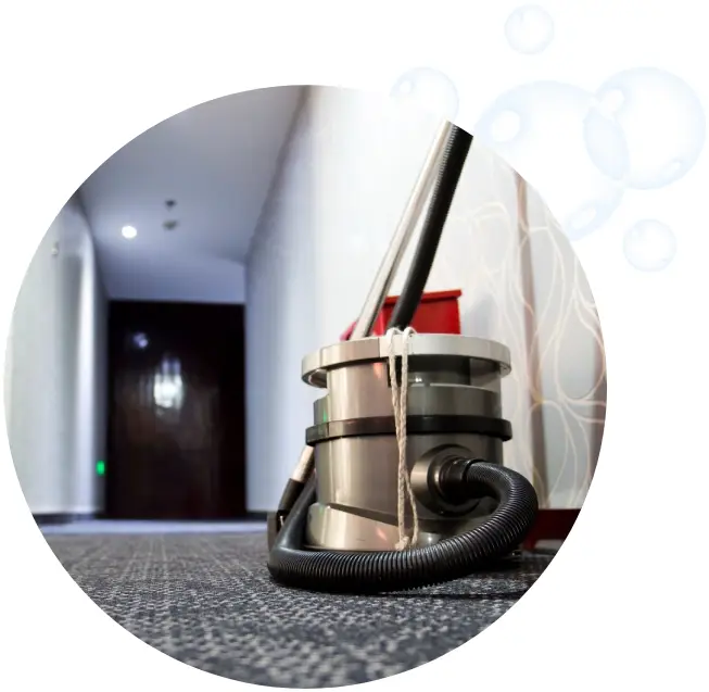 A vacuum cleaner on the floor of an office building.