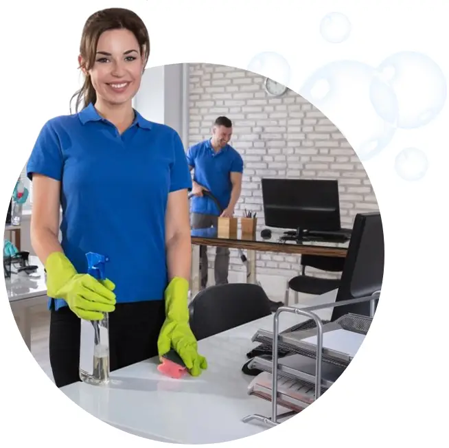 A woman in blue shirt and yellow gloves holding a spray bottle.